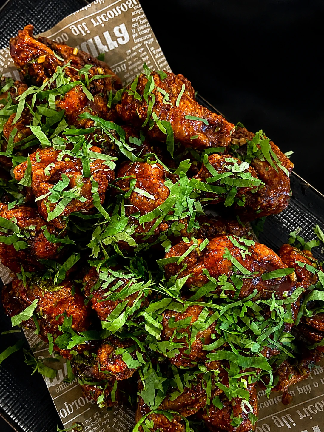 Sweet and hot Korean fried chicken with fresh greens